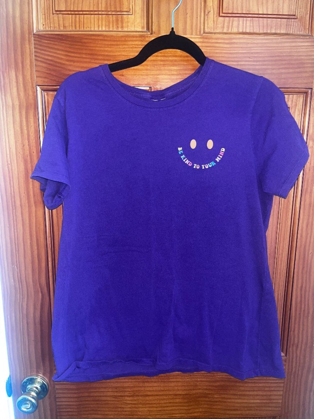 Purple T-shirt with "Be Kind To Your Mind" smiley face